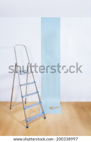 Aluminum ladder in interior room with roll paper