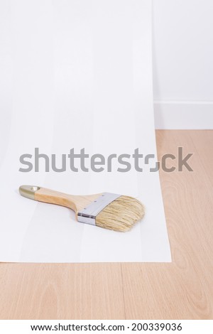 Paint brush and paper in interior room