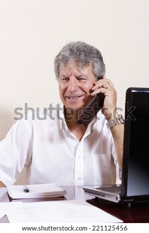 Businessman working with laptop in a interior office.
