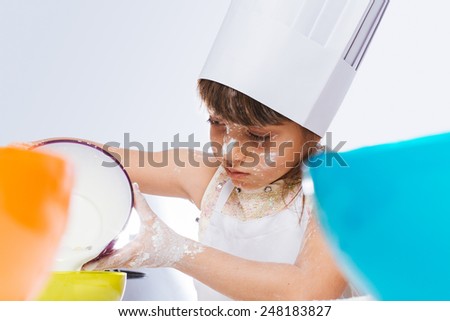 Caucasian girl making a cake, isolated on white background