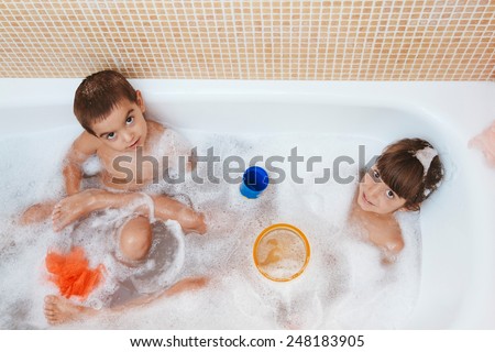 Two brothers playing in the bath together