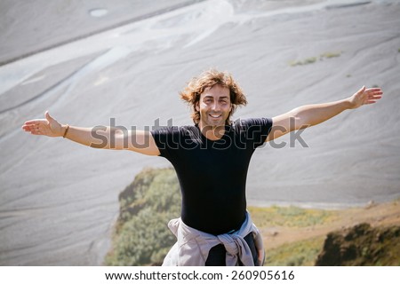 Freedom man in nature on iceland happy with arms enjoying free happiness