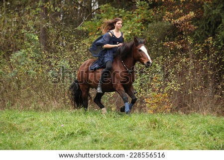 Amazing girl with horse running without bridle and saddle in nature