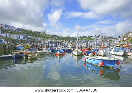 Fishing boats moored in the inner harbour at Mevagissey on a beautiful blue sky day, South Cornwall, England, United Kingdom