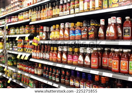 TORONTO, CANADA - SEPTEMBER 13, 2014: Sauces and tomato ketchup bottles on shelves in a supermarket. Europe and North America are the leading consumers of sauces, dressings and condiments in the world
