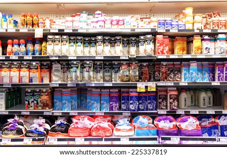 TORONTO, CANADA - SEPTEMBER 13, 2014: Selection of milk and dairy products on shelves in a supermarket. Milk and dairy products are the main sources of protein and calcium.