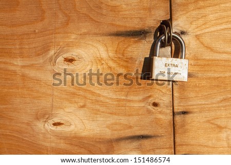 Extra Top Security. Hinged lock on a wooden door. Canon EOS 5D Mark II.