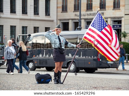 BERLIN, GERMANY - MAY 18, 2009: cute young woman with an American flag on the street of Berlin on May 18, 2009. Canon 5D.