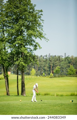 Man playing golf on beautiful sunny green golf course