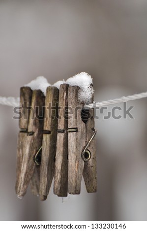 clothes pins covered with snow