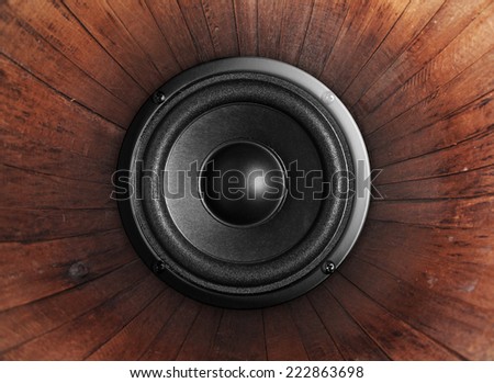 Audio music speaker on wood background
