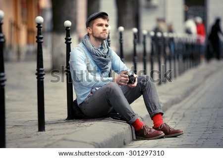 nice man in red socks with a camera