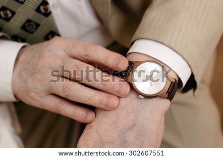 old hands with watch