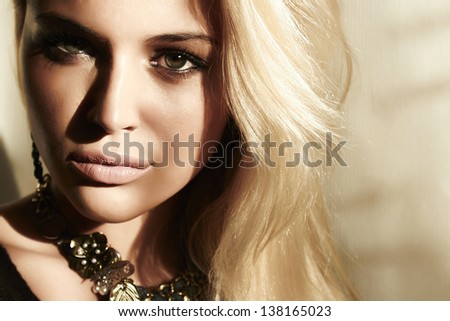 portrait of beautiful blond woman in daylight. shadows on the face