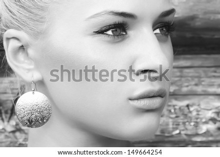 black and white portrait of beautiful blond girl near wooden wall.beauty woman.village