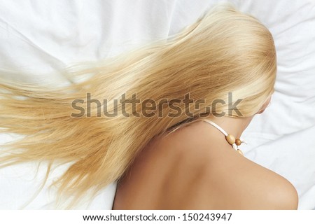 long blond hair. beautiful blond woman on the bed. sleeping. beauty woman