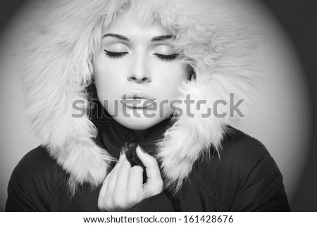beautiful woman with fur. white fur hood.monochrome