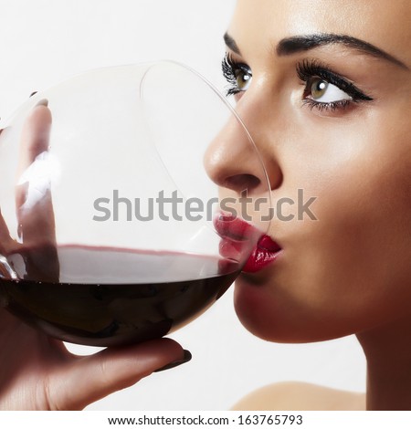 Beautiful Blond Woman Drinking Red Wine.Make-Up.Red Lips.Wineglass