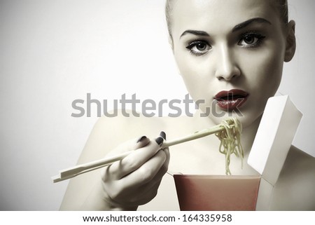 beautiful woman are eating.red lips.Chinese sticks.food menu