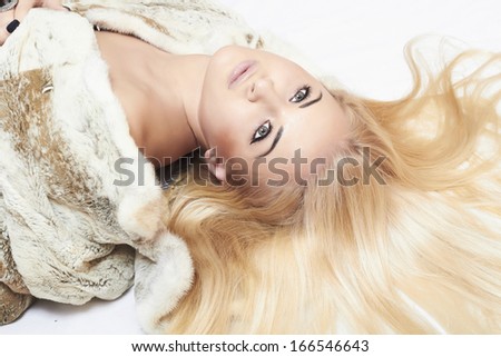 Beauty Fashion blond Model Girl in Mink Fur Coat. Beautiful Woman in Luxury Fur Jacket . Winter Fashion. closeup