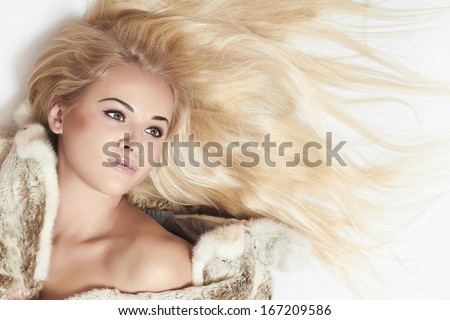 Beautiful blond woman in fur coat.