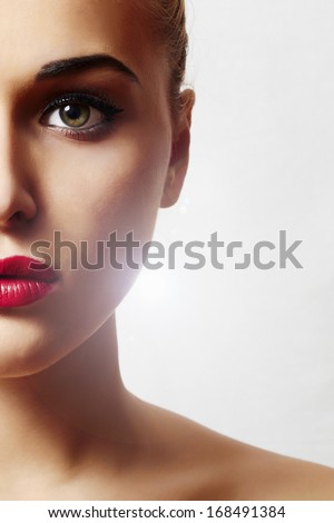 Beautiful Face of Young Woman with Clean Fresh Skin close up. Beauty Portrait.  Perfect Fresh Skin. Pure Beauty Model. Youth and Skin Care Concept. half face