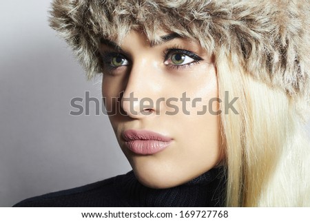Beautiful Blond Woman in Fur Cap. Beauty Fashion Girl. Winter Style. Sweet Lips. Shining Hair.