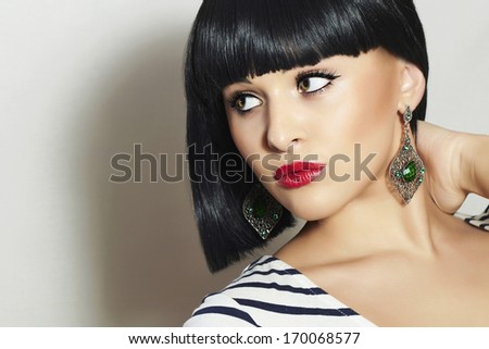 Beautiful Brunette Girl. Healthy Black Hair. Bob Haircut. Red lips. Beauty woman jewelry