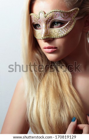 Beautiful Blond Woman in a Carnival Mask.Masquerade. Sexy Girl. Beauty & Fashion. Naked with Long Hair