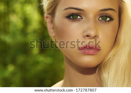 Beautiful Blond Woman in Forest. Summer Sunlight.Beauty Girl. Make-up