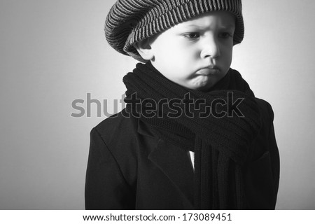 Sad Little Boy in Cap. Style Kid. Fashion Children. Handsome Child in Scurf. Winter wear