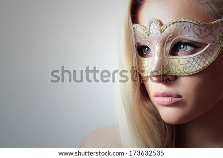 Beautiful Blond Woman in a Carnival Mask.Masquerade. Sexy Girl. Lovely. Close-up Portrait