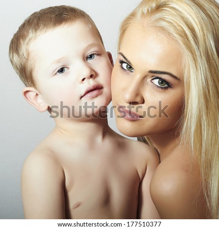 Young Mother Hugging Child. Beautiful Blond Woman with Little Son. Happy Family