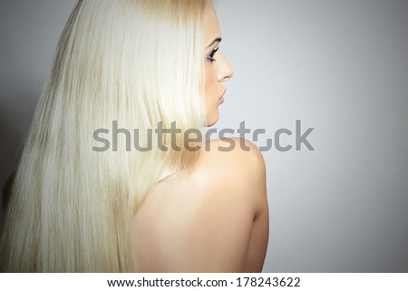 Blond Hair of Naked Beautiful Girl. Back side of Young Woman with Straight Hair
