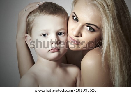 Young Mother Hugging Child. Beautiful Blond Woman with Little Son. Happy Beautiful Family