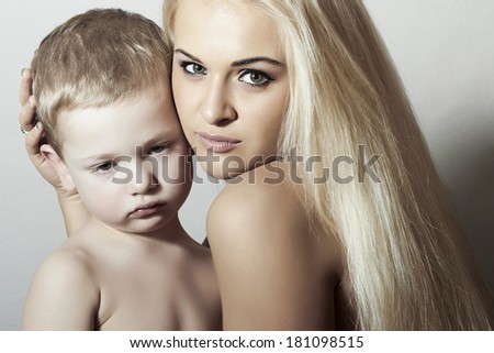 Young Mother Hugging Child. Beautiful Blond Woman with Little Son. Happy Beautiful Family. Sad kid
