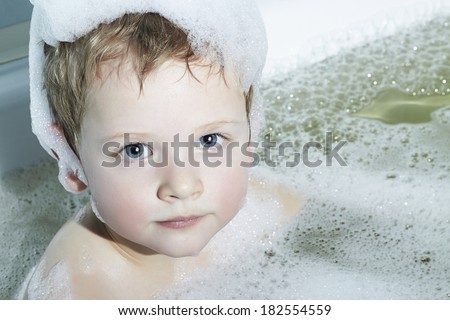 Funny Little Boy in the Bath.Funny Child in Foam on the Head