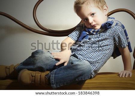 Child. Handsome little boy.Fashion Children.Emotion.Vintage furniture