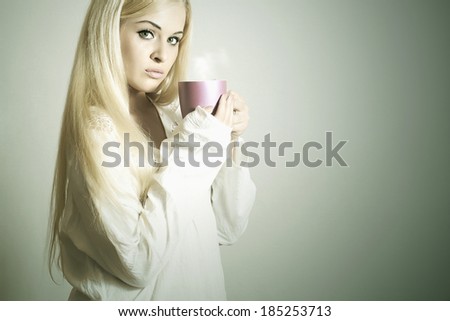 Beautiful blond woman drinking Coffee. Vapor Cup of tea. Hot drink. girl in the Morning after sleep