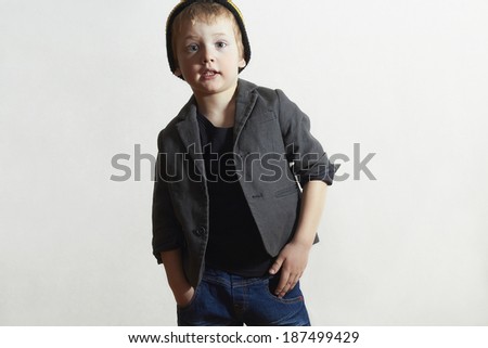 Fashionable little Boy in cap and jeans.stylish kid in blazer. Fashion Children.