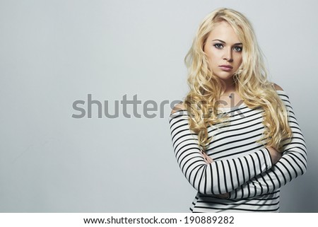 Beautiful blond woman in dress. Curly hair. Beauty Girl. stripes. sailor
