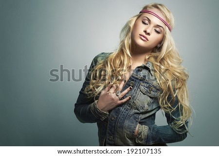 beautiful girl in jeans.denim wear.blond woman.hippie style.closed eyes