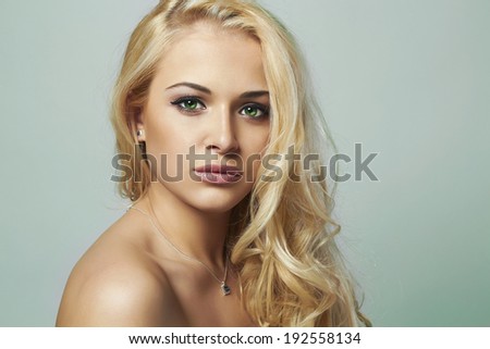 young woman.beautiful blond girl with green eyes. Curly hair.toned