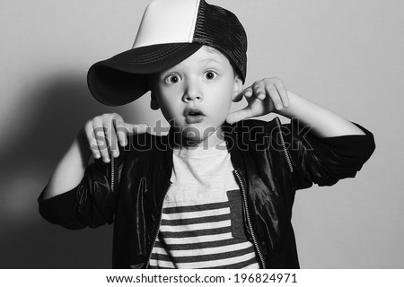 monochrome portrait of Funny little boy.Hip-Hop Style. fashion children.handsome.Boy in Tracker Hat. Young Rapper. Funny Child in Cap. 4 years old. Surprised emotion