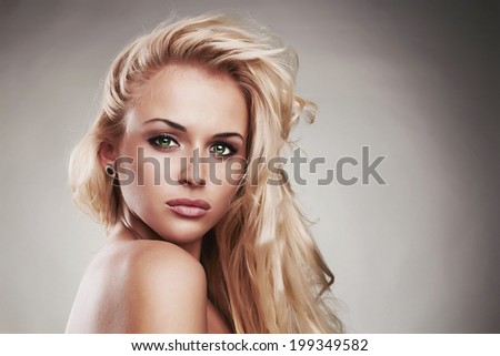 Fashion portrait of young beautiful woman.Sexy Blond girl. Gray Background.Your text here