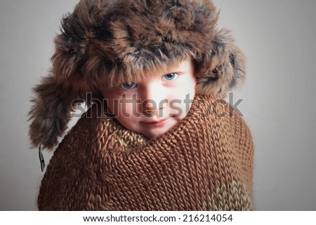 frozen child in fur Hat.fashion winter style.little boy.children.cold