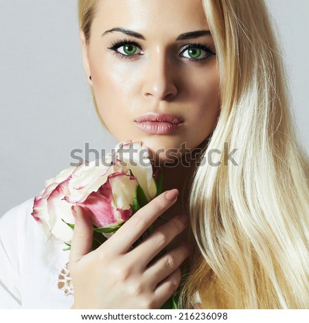 beautiful blond woman with flowers.girl and roses.close-up portrait.most beauty model.skin care.make-up