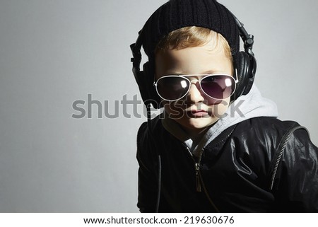 little DJ. funny boy in sunglasses and headphones.5 years old child listening music in headphones. deejay