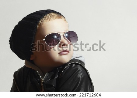 Fashionable little boy in sunglasses.Child.Winter style.Kids fashion.Little model in black cap - stock photo