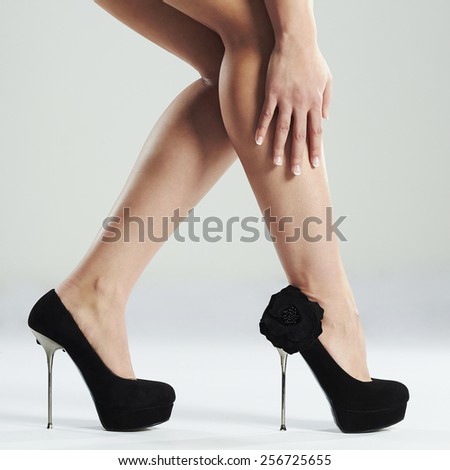 Slim long sexy woman legs.Perfect female legs wearing high heels.French Manicure